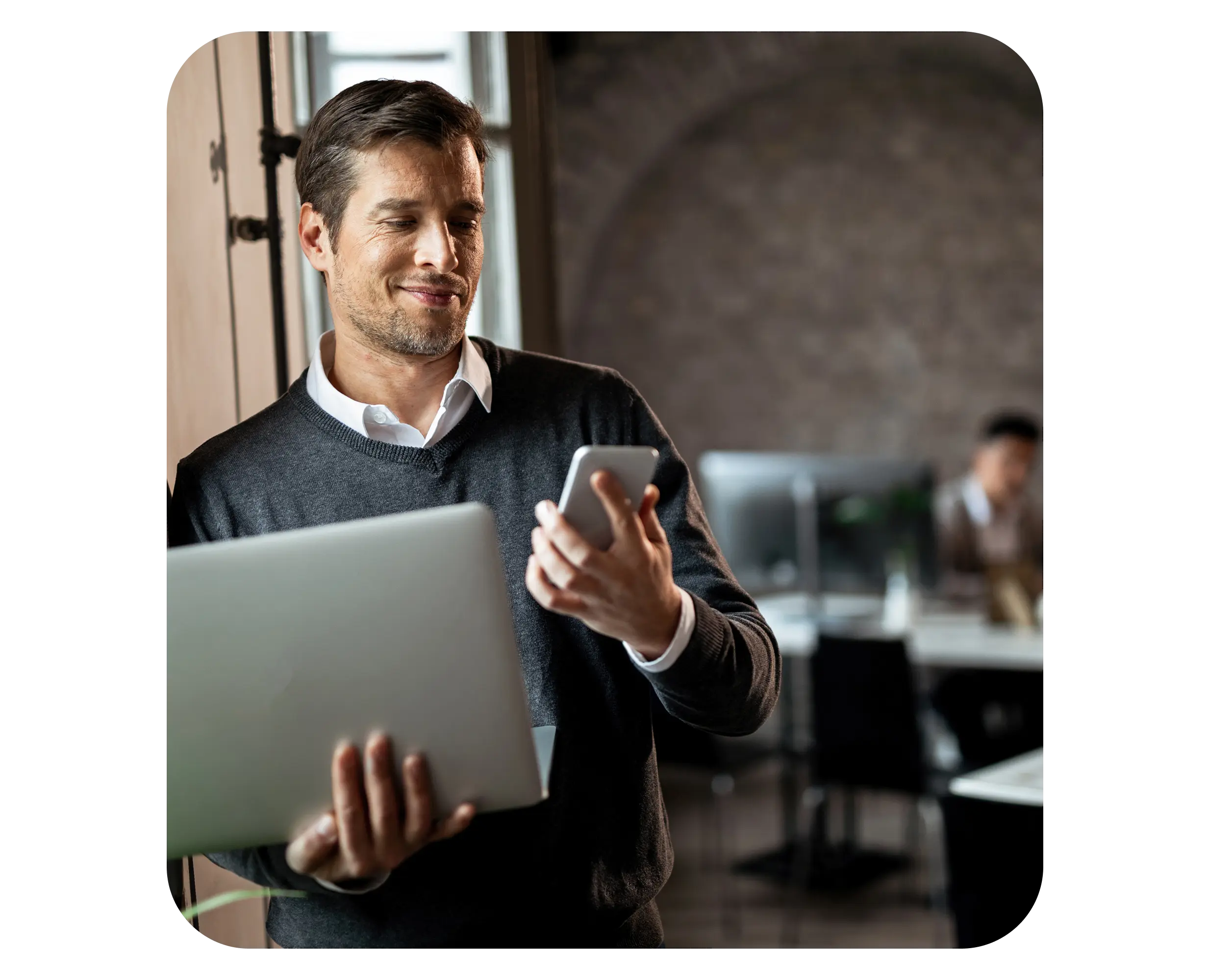 Entrepreneur managing business setup in Serbia using laptop and smartphone